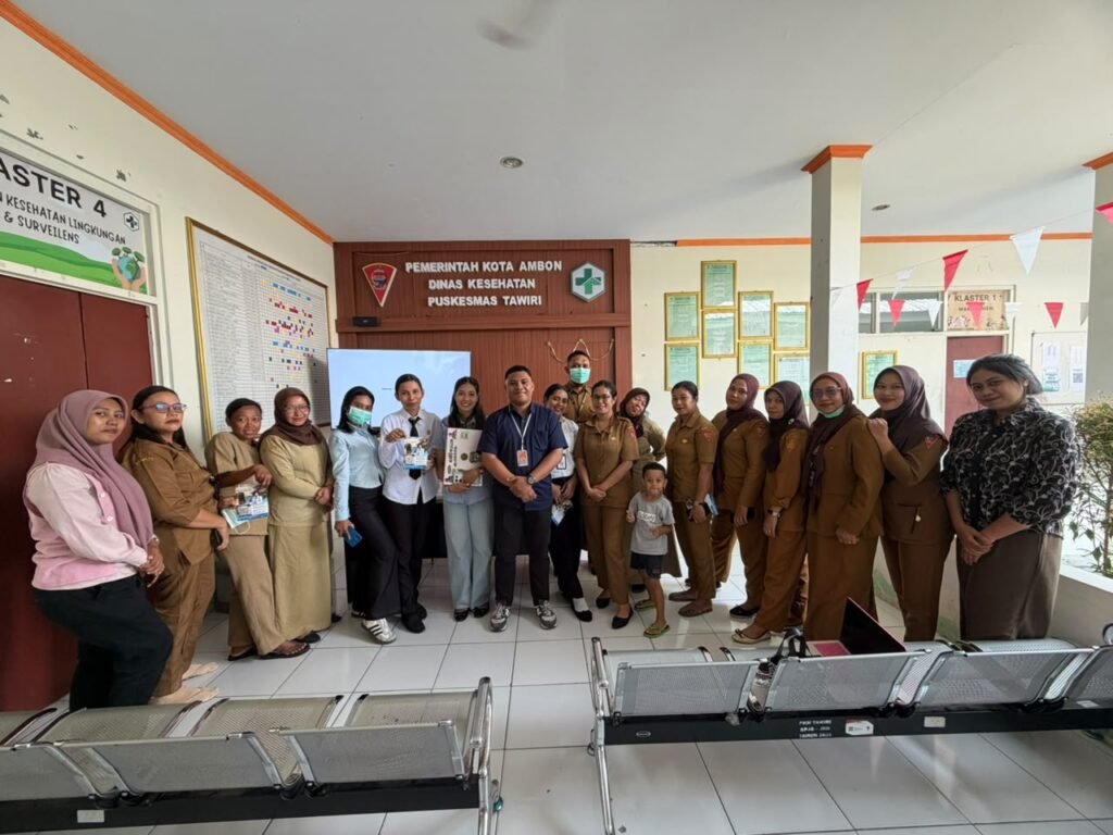 Staff and visitors pose under the Puskesmas Tawiri sign